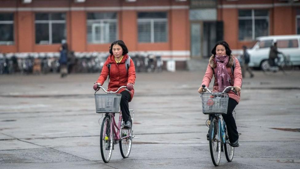 North Korean women cycle across Hamhung Square on February 03, 2019 in Hamhung, North Korea. 