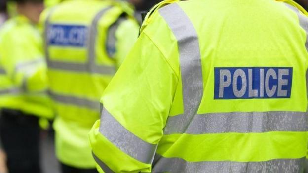 A close-up of a high-vis police jacket
