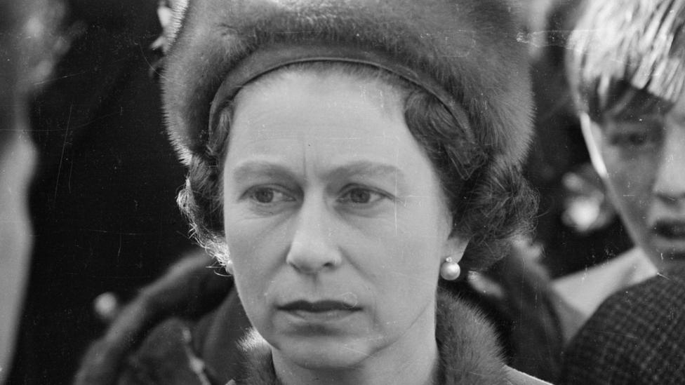 Queen Elizabeth II in Aberfan. It is a close-up, haunted image in black and white.