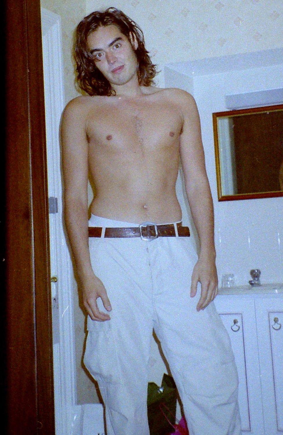 Undated handout photo issued by Metropolitan Police of Russell Brand, which was shown to the jury in his trial at Southwark Crown Court, London. The image appears to show Mr Brand shirtless and wearing white trousers. Issue date: Thursday October 15, 2026.