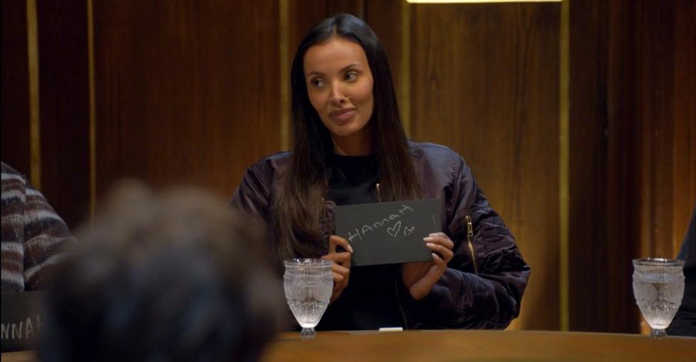 Maya Jama holding her slate, on which she has written Hannah
