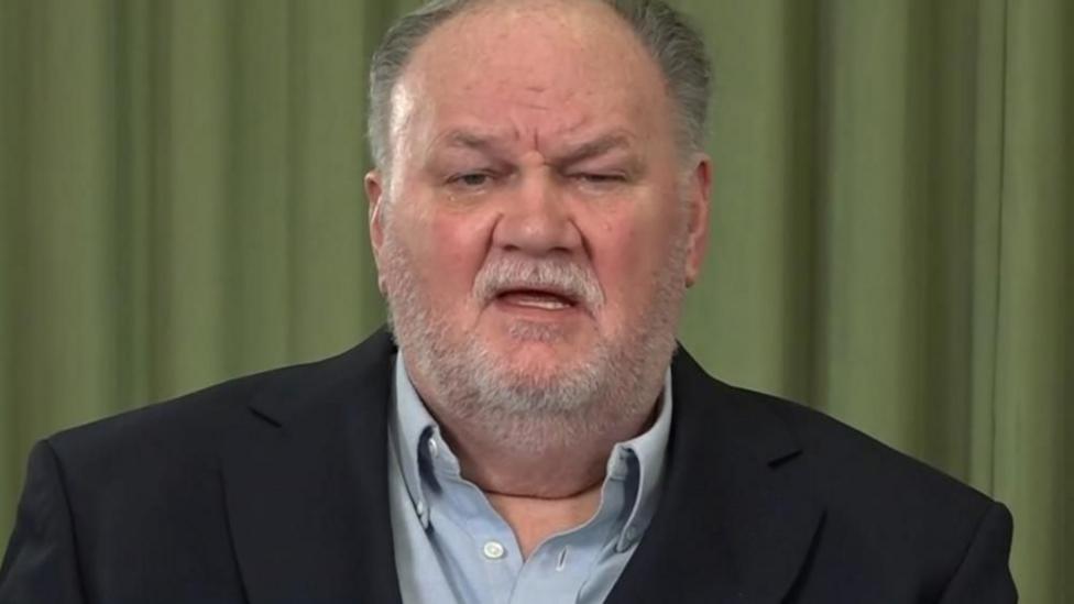 Thomas Markle, an older white man with grey hair and a short white beard. He is wearing a dark blue suit jacket and light blue shirt.