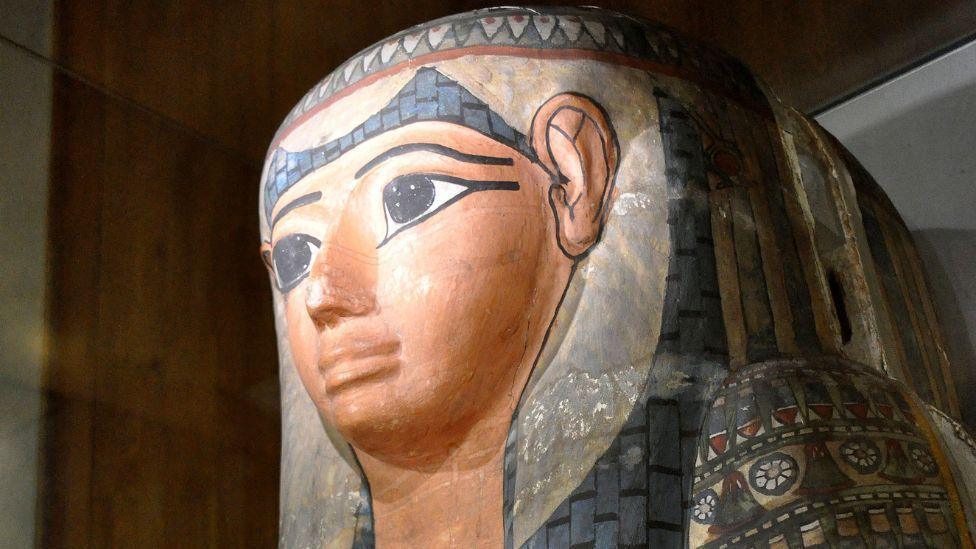 Lady Shep-En-Hor's sarcophagus on display at The Hunterian Museum in Glasgow. The sarcophagus is multicoloured and has a number of Egyptian hieroglyphics on it.