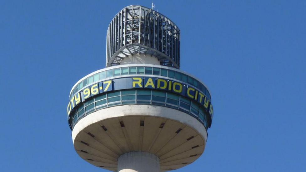 A close up of the tower. It has Radio City 96.7 wrapped around the top in yellow lettering.