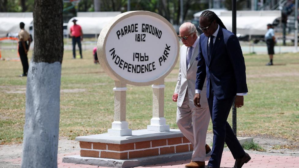 King Charles and Steven Jacobs walk past the sign for Independence Park