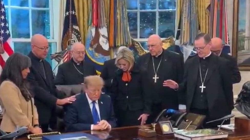 Trump praying in the Oval Office alongside a group of US bishops.
