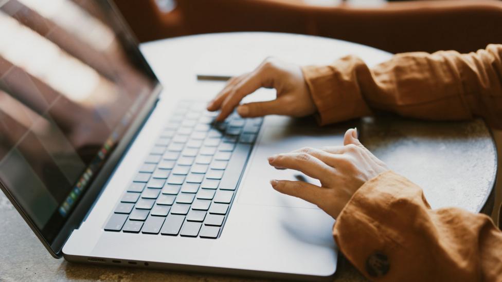 Hands on a computer keyboard