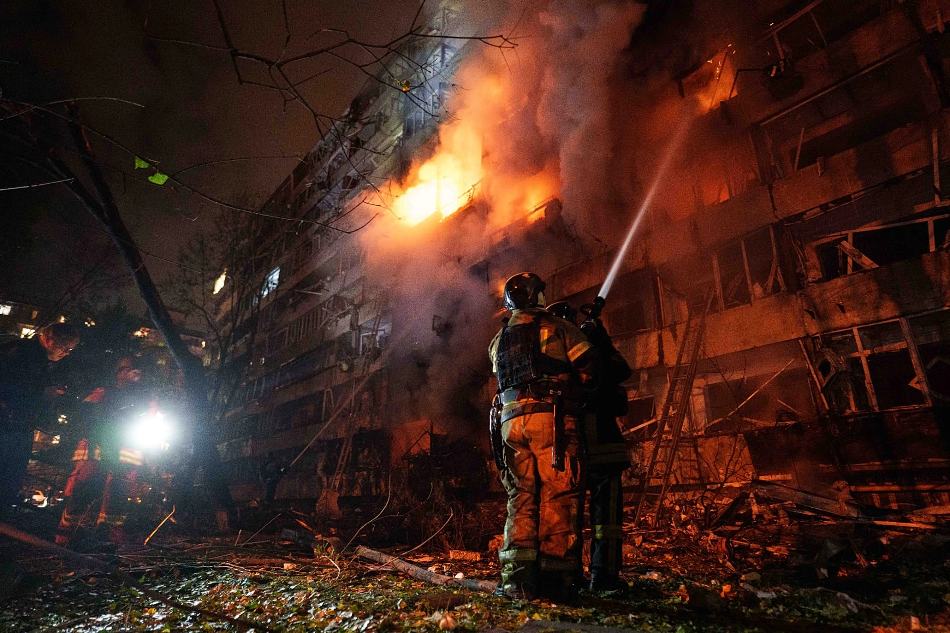 Rescue workers put out a fire of a multi-storey residential building damaged in a Russian missile strike on Kyiv, 13 October, 2026