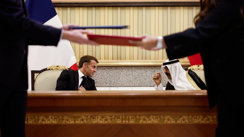 Sheikh Meshal and Mr Macron witness the signing of an agreement at Bayan Palace, in Kuwait City. Reuters