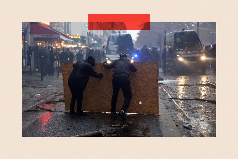 Protesters taking cover behind a plywood board face off with French gendarmes amid clashes during a demonstration organised by labour unions in Paris as part of nationwide protests called by the 'Yellow Vests' movement, joined by French high school and university students against the cost of living and rising fuel prices, in France.