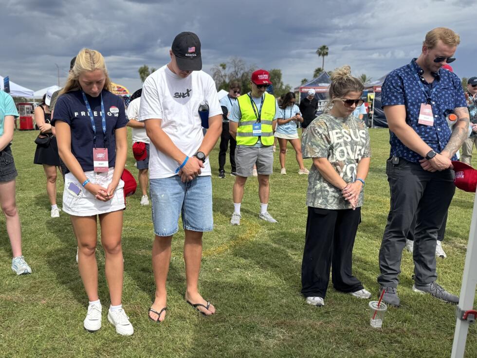 Members and supporters of Turning Point USA pray together in Paradise Valley Park in Phoenix, Arizona, on October 10, 2026