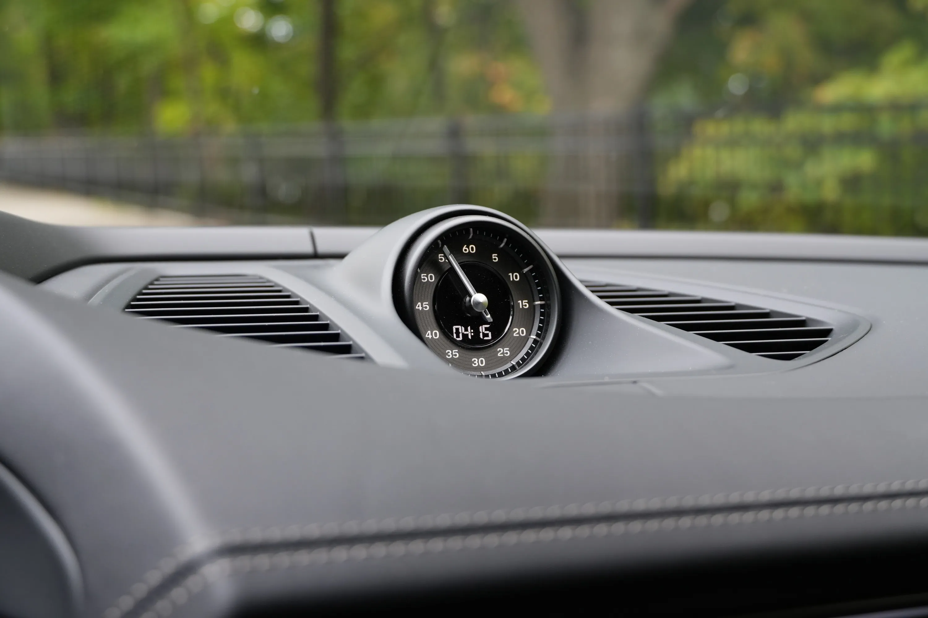 A clock sits atop a dash.