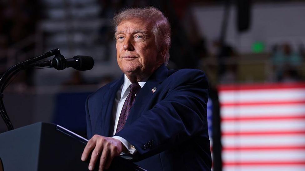 Donald Trump speaking at lecturn.