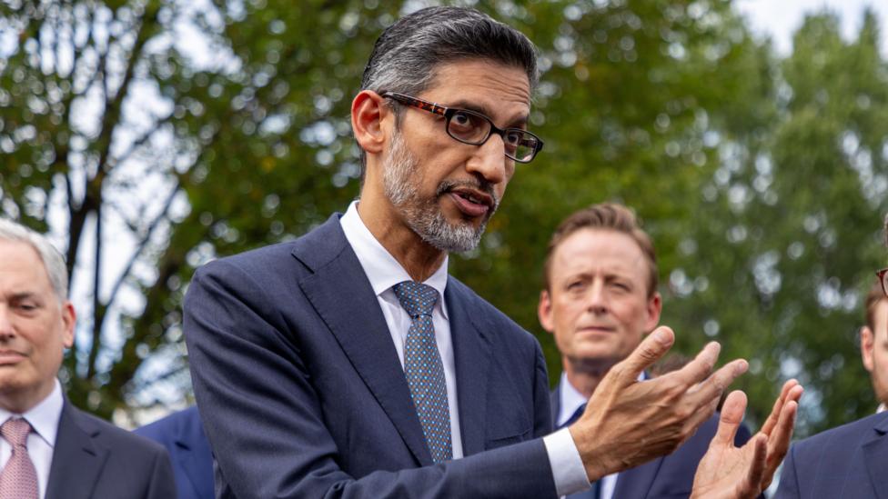 Google CEO Sundar Pichai gesturing with his hands while speaking to reporters outside of the White House.