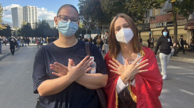 Two young female protesters pose for a picture