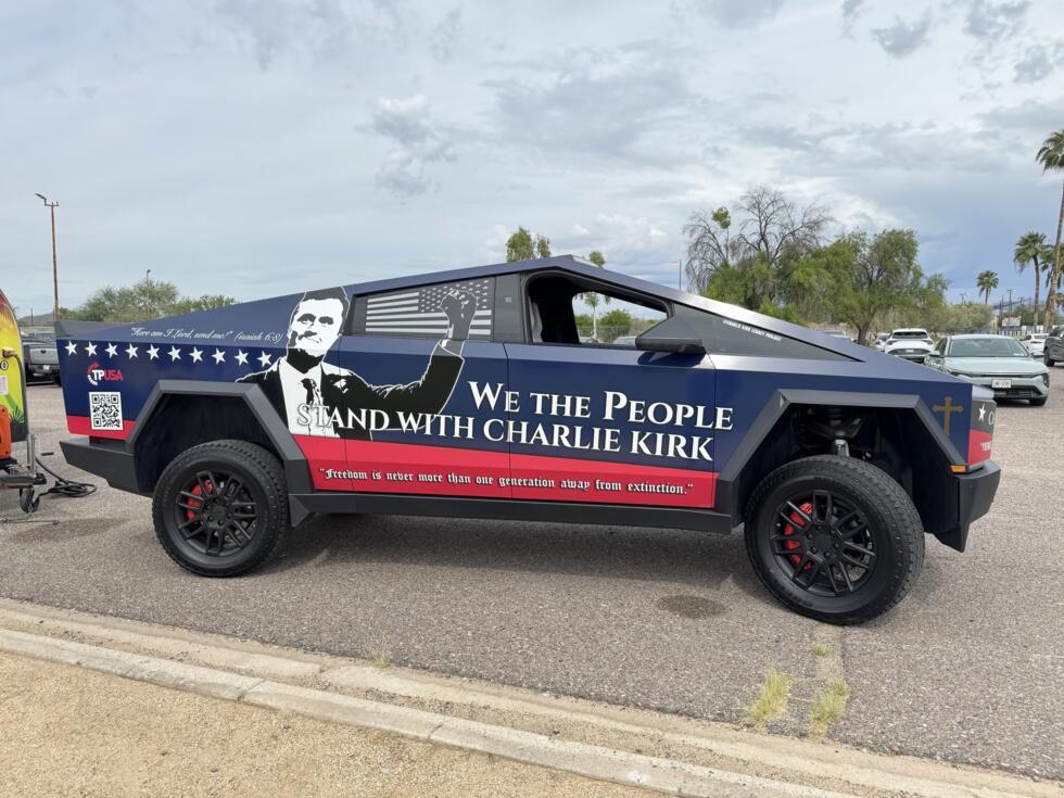 A Tesla Cybertruck featuring a portrait of Charlie Kirk parked at the entrance to a Turning Point USA rally in Phoenix, Arizona, on October 10, 2026