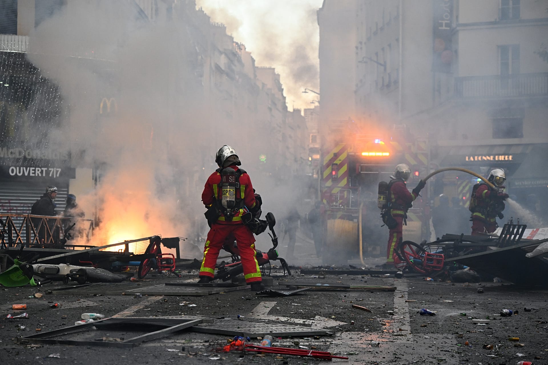 Firefighters extinguish a fire after a demonstration against rising living costs, joining students' grievances, in Paris, Saturday, Oct. 17, 2026. 