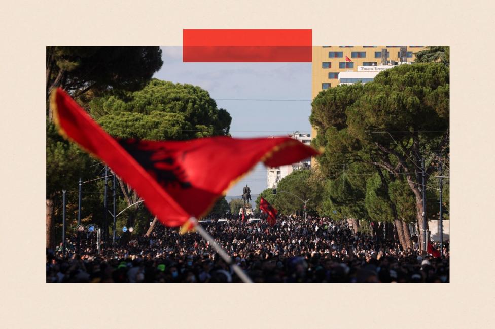 A person waves an Albanian flag as a crowd of demonstrators gathers near the Skanderbeg Monument during an anti-government protest by students in Tirana, Albania, October 24, 2026. REUTERS/Valdrin Xhemaj TPX IMAGES OF THE DAY