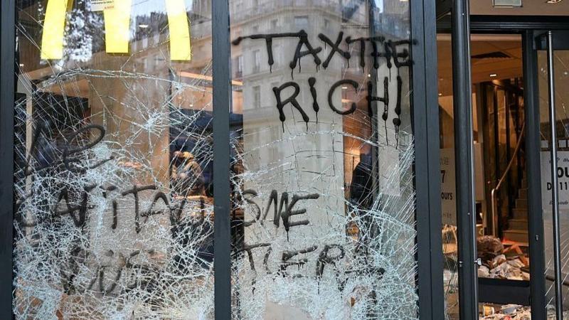 This photograph shows the entrance of a McDonald's covered in graffiti and damaged a day after nationwide protests against the "high cost of living", in Paris on October 18, 2026.