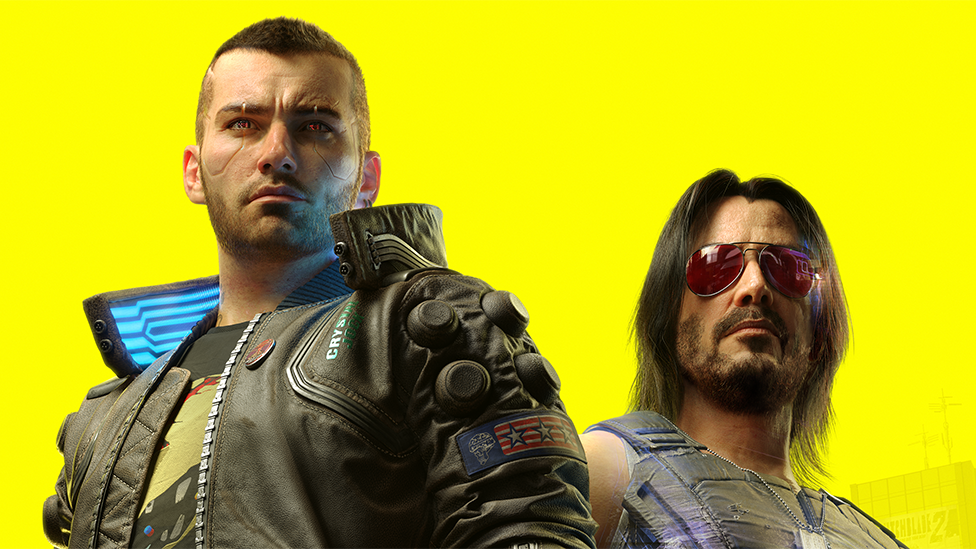 Artwork from Cyberpunk 2077 shows player character V — a shaven-headed male wearing a leather jacket over a graphic t-shirt. He's standing next to Johnny Silverhand, who bears the likeness of Keanu Reeves. He's got black, shoulder-length hair and wears a leather, protective vest with matching trousers. He has a silver, cybernetic left arm. The camera is tilted slightly upwards, and the background opens to reveal a panorama of futuristic flying vehicles and skyscrapers, overlaid with a bright yellow filter.