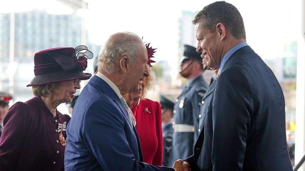 The King and Rhun ap Iorwerth shaking hands near the Senedd entrance