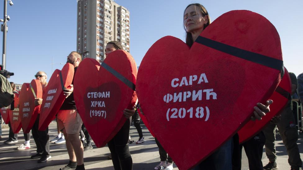 Residents of Serbia commemorate the victims of the Novi Sad railway station collapse in Novi Sad, Serbia, by holding large red hearts, with a black stripe on one side, which bear the victims' names in Serbian and their years of birth in white lettering.