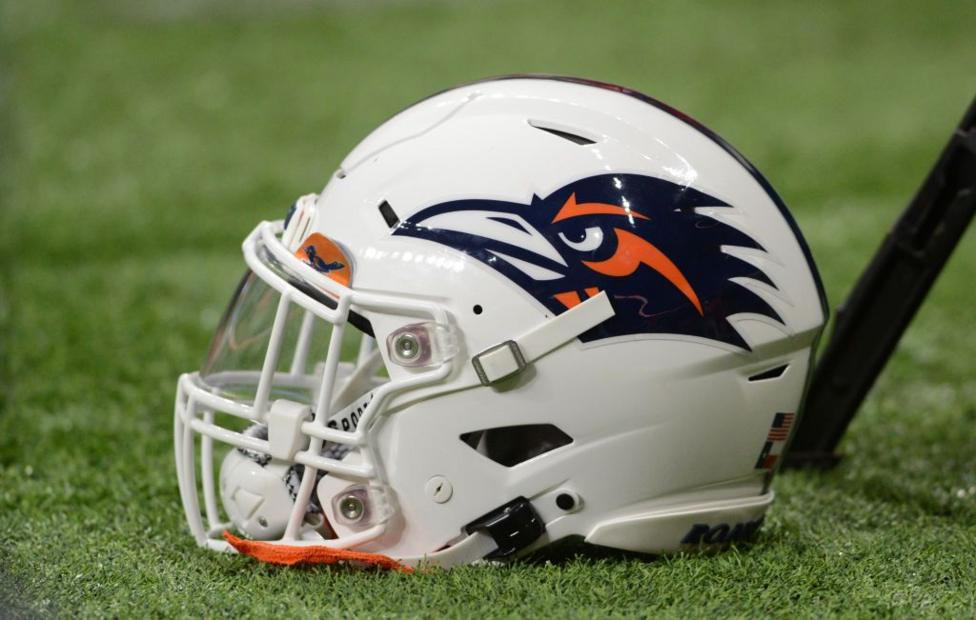 A photo of a University of Texas at San Antonio football helmet sitting on the turf