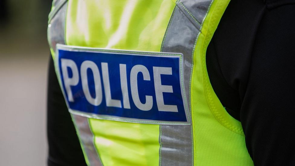 The back of a police officer's hi-vis uniform.