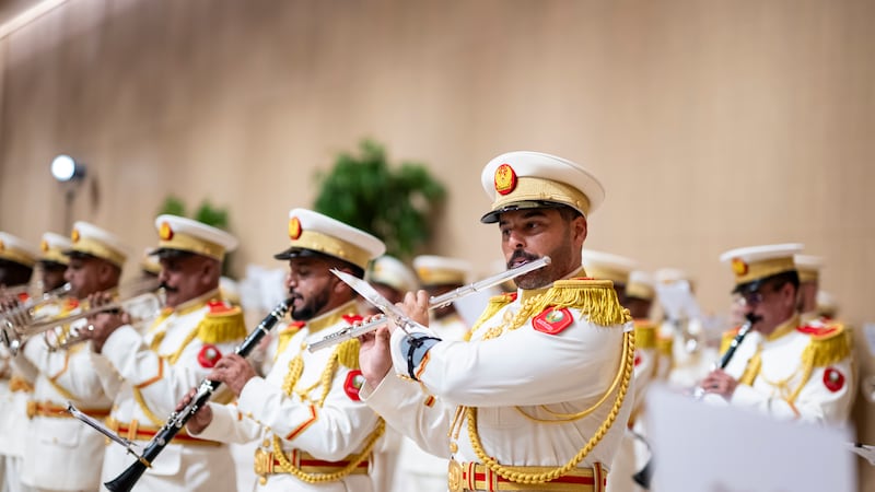 A UAE military band strikes up to welcome Mr Macron to Abu Dhabi. UAE Presidential Court