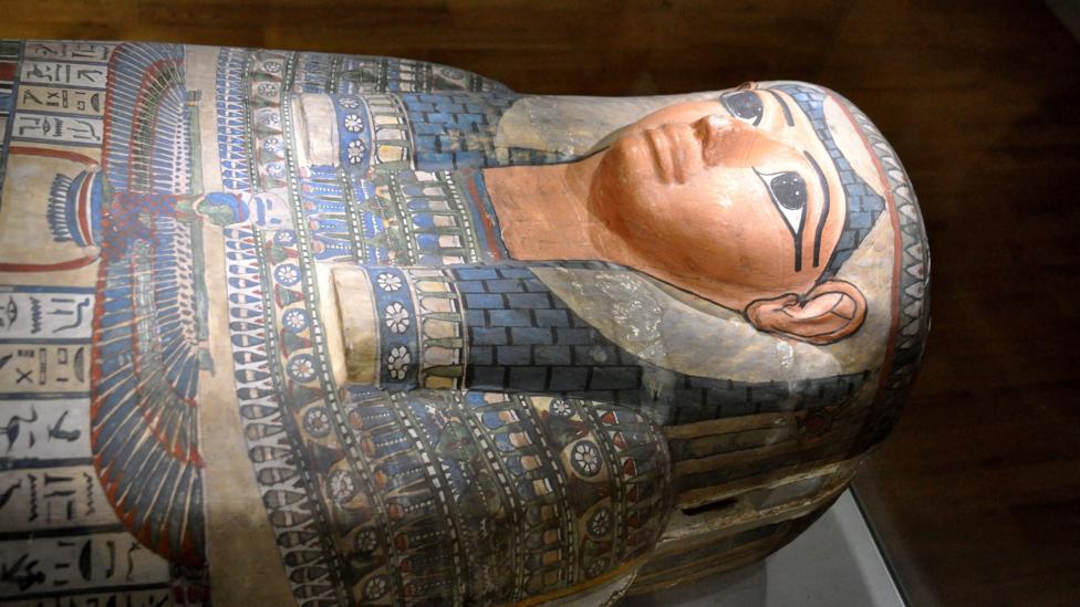 Lady Shep-En-Hor's sarcophagus on display at The Hunterian Museum in Glasgow. The sarcophagus is multicoloured and has a number of Egyptian hieroglyphics on it.