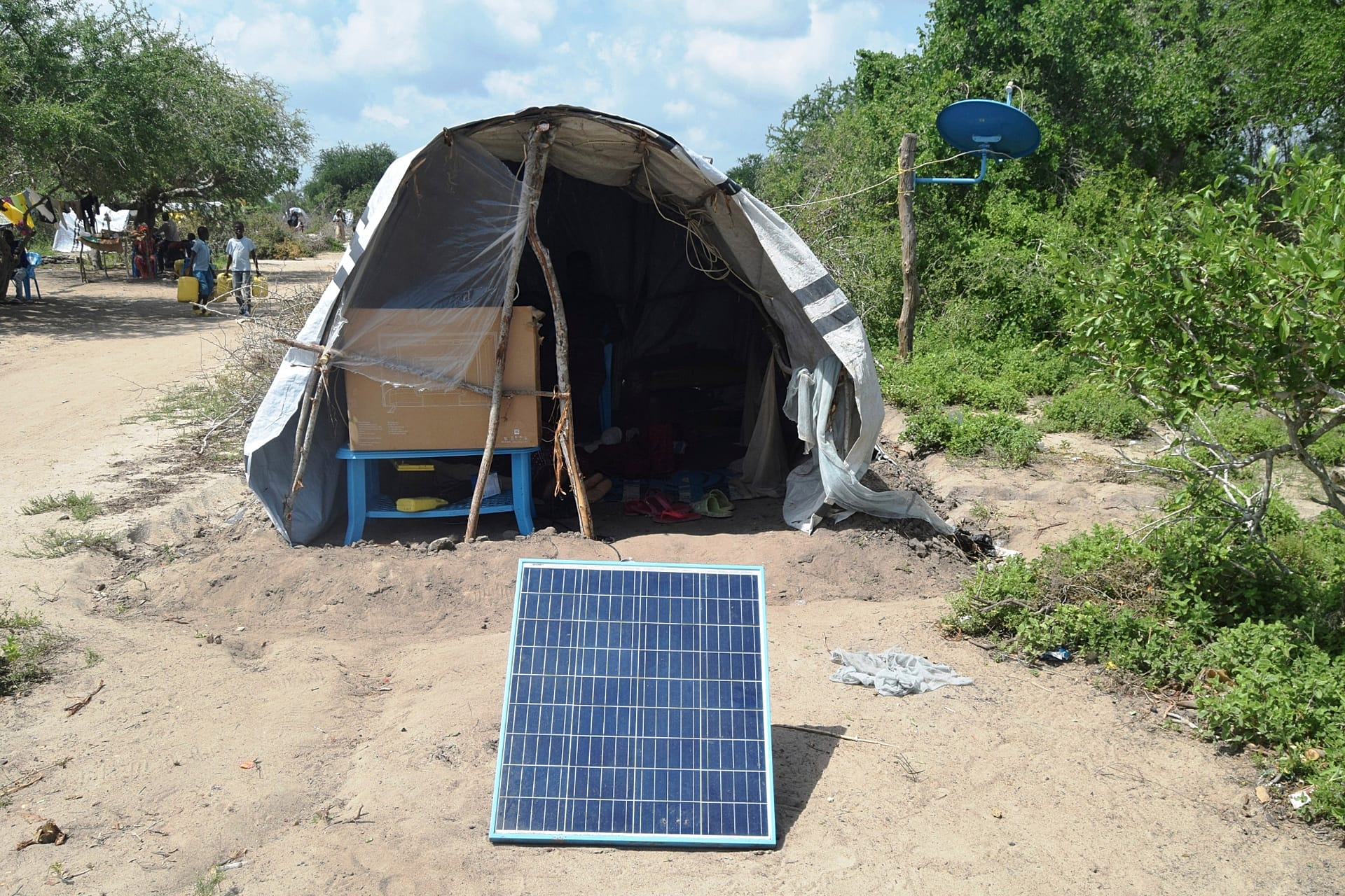 FILE - A family displaced by flooding has a solar panel set up outside their tent in Garsen town within Tana River County, Kenya, Dec. 3, 2023.