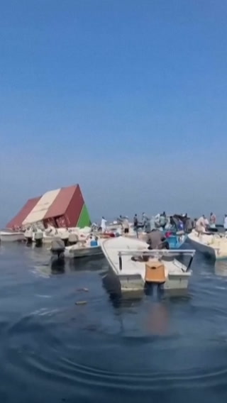 Containers and debris seen floating near the Strait of Hormuz
