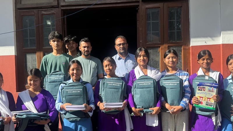 Principal Rajendra Dawadi (far right behind) with pupils from the Tribhuvan Trishuli secondary school who were provided with books, bags and tents to resume school. Photo: Rajendra Dawadi