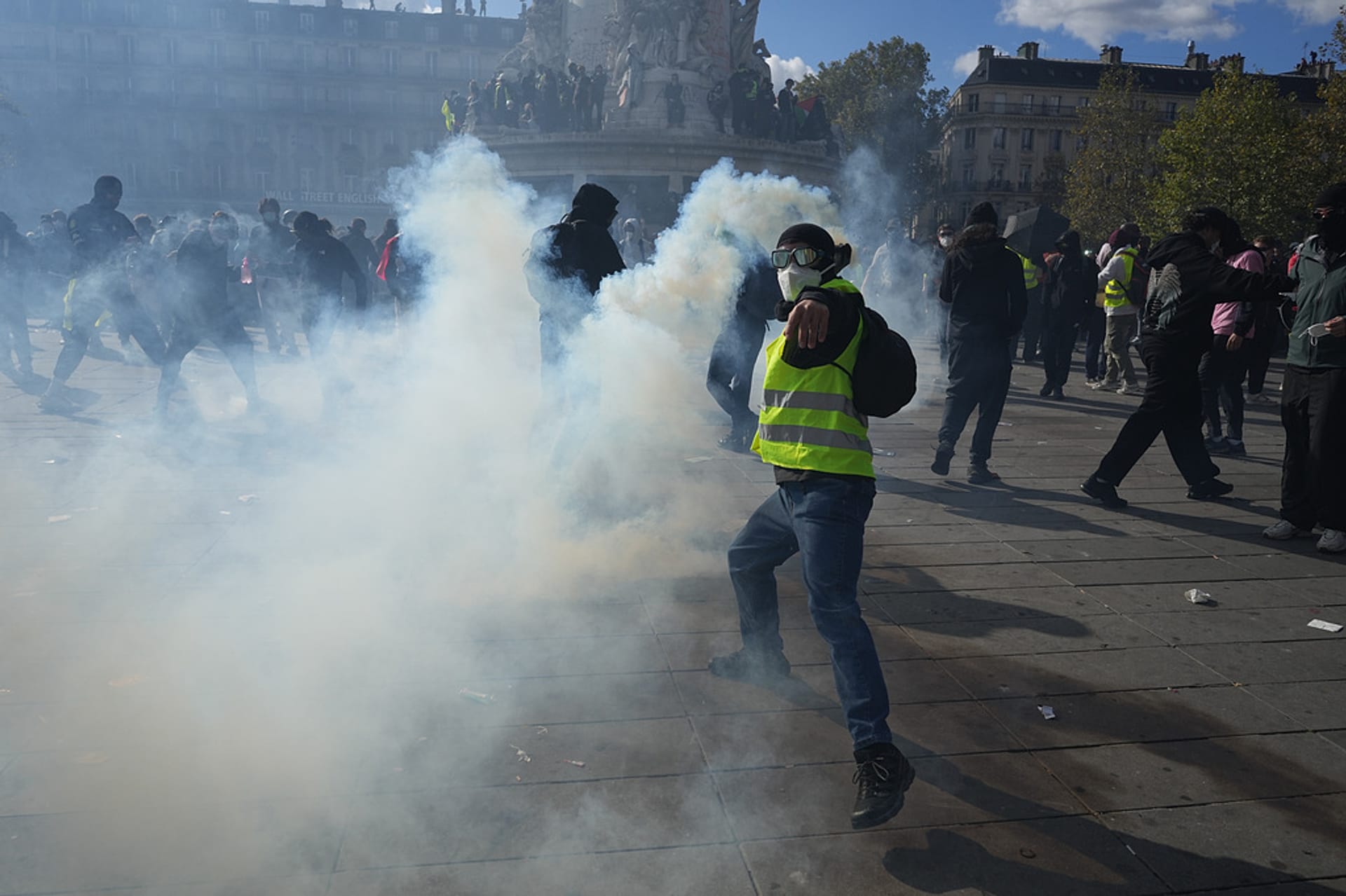 A protester throws clashes with police during a protest against rising living costs, joining students' grievances, in Paris, Saturday, Oct. 17, 2026