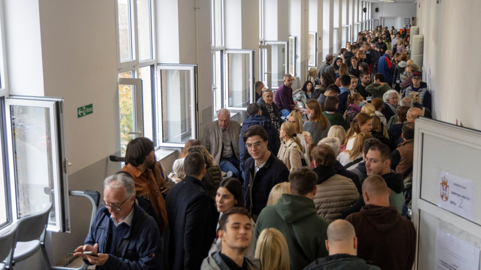 People wait in line to cast their votes during the parliamentary election in Belgrade, Serbia