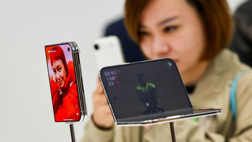 Chorshanba kuni Kaliforniya shtatining Kupertino shahridagi taqdimotda namoyish etilayotgan yangi iPhone Duoni yaqindan ko‘zlayotgan shaxs.