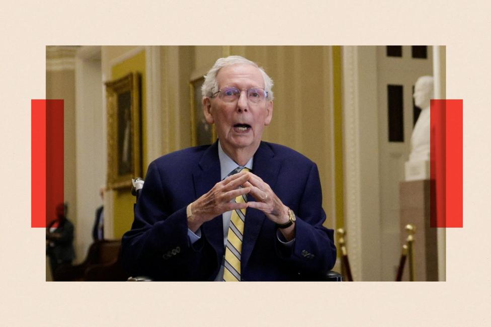Mitch McConnell steeples his fingers. He wears a navy blue suit and stripey tie