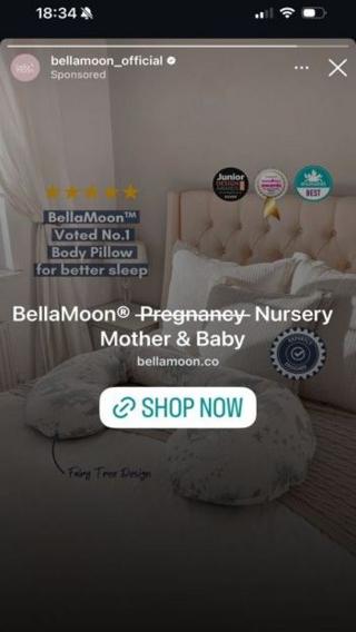 A screenshot of an advert on Instagram showing a body pillow on a bed, with text over it reading "Bella Moon Pregnancy Nursery Mother & Baby", with the word "Pregnancy" crossed out. 