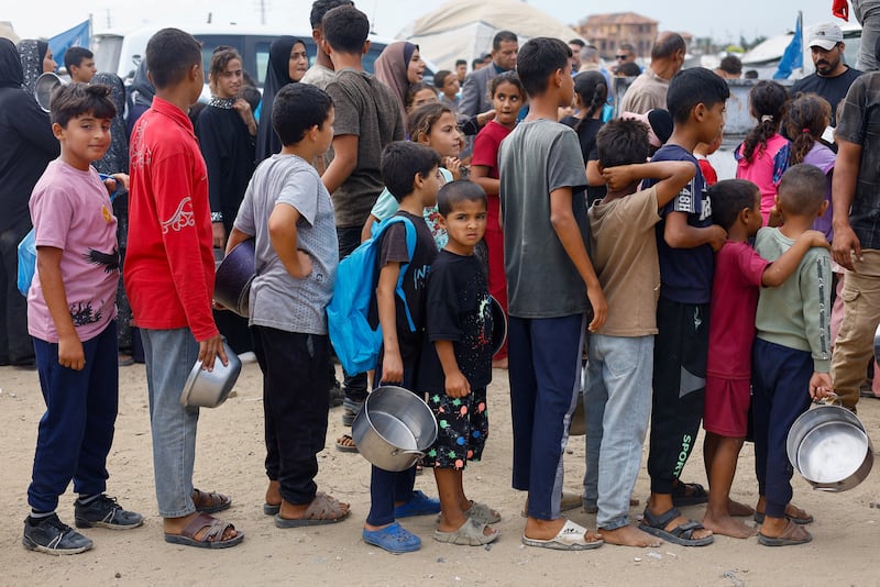 Children wait to receive food from a soup kitchen funded by the World Food Programme in Deir Al Balah, central Gaza. Reuters