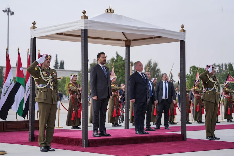 Iraqi Prime Minister Ali Al Zaidi with Jordan's King Abdullah II during a welcome ceremony in Amman, on October 26. AFP