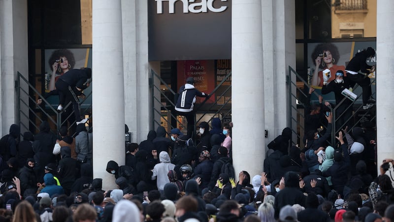 Протестующие перелезают через заборы в Нанте. Reuters