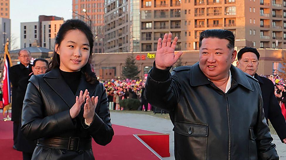 This picture taken on February 16, 2026 and released by North Korea's official Korean Central News Agency (KCNA) on February 17, 2026 shows North Korean leader Kim Jong Un (C) and his daughter Ju Ae (L) responding to citizens at the inauguration ceremony of 10,000 flats at fourth stage in Hwasong area of Pyongyang.