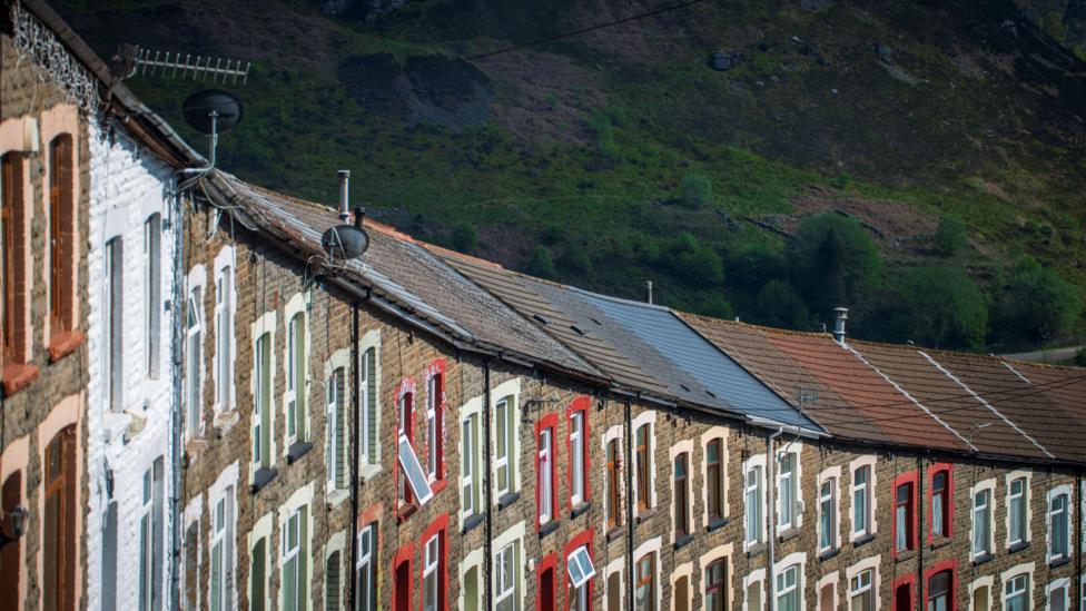 A row of brick houses with colourful windows
