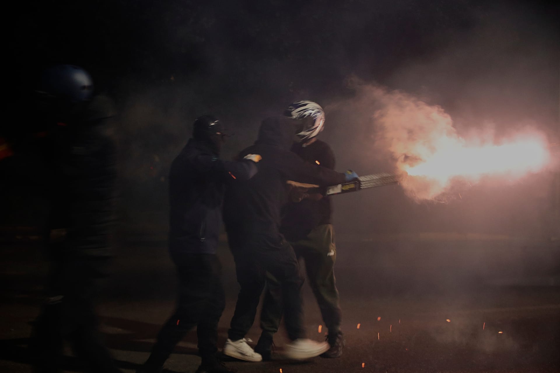 Protesters throw fireworks at riot police during an anti-government protest in Tirana, Albania, Monday, Oct. 19, 2026.