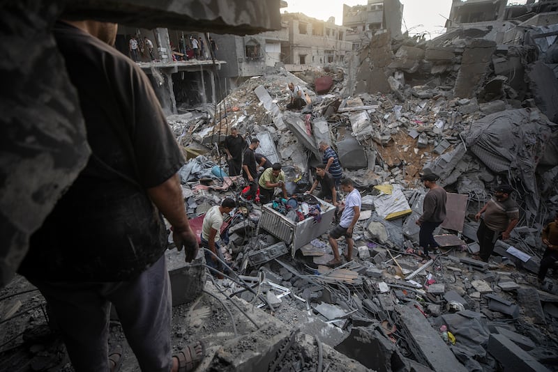 Palestinians inspect the rubble of destroyed homes after an Israeli strike on Gaza city. EPA