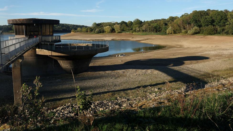 Ardingly reservoir with muddy banks and concrete  platform and low water.