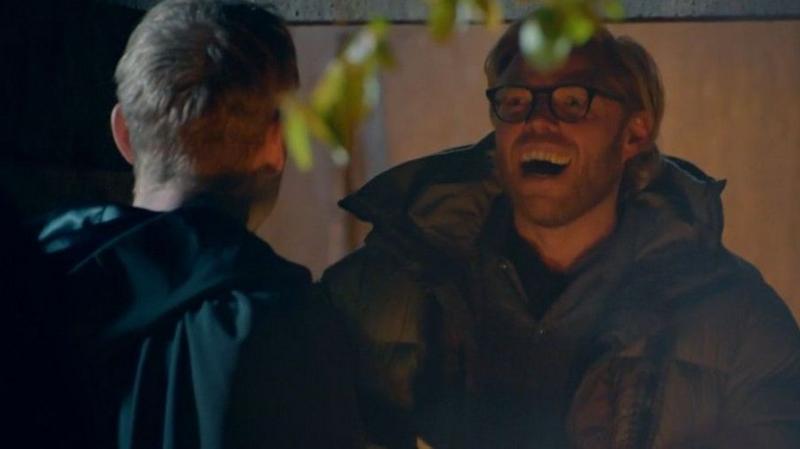 Rob Beckett laughing as he faces James Acaster
