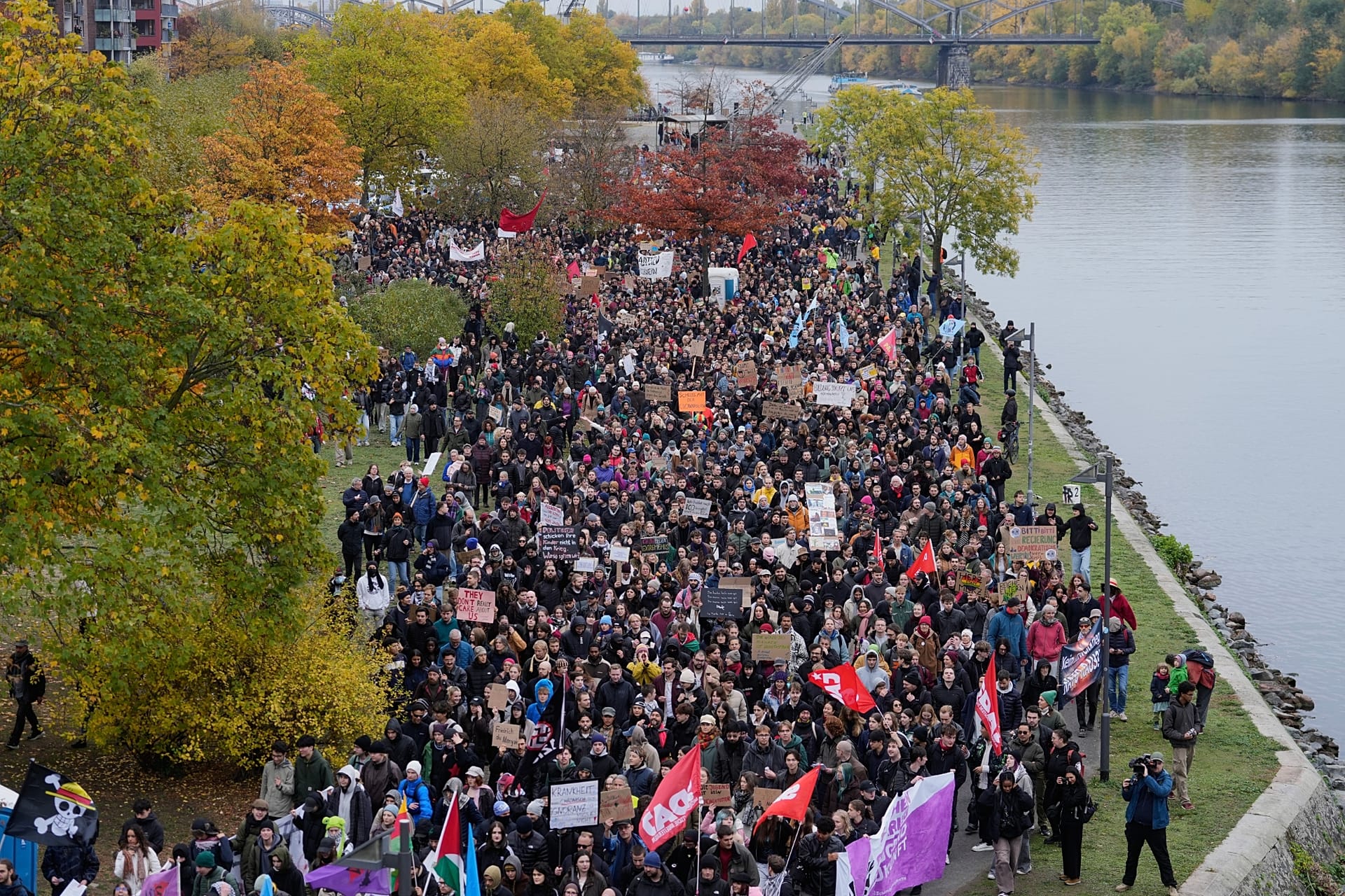 Demonstrators gather at the banks of the river. Main for a protest under the slogan 'Gen Z Takes Care of It' in Frankfurt, Germany, Saturday, Oct. 31, 2026.