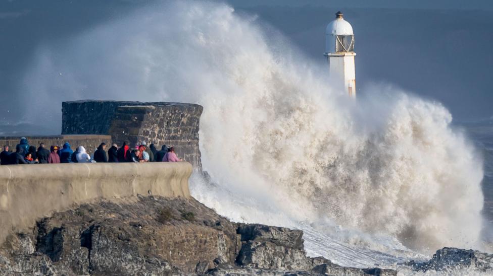 Waves crash against the harbour wall in Porthcawl, Wales
