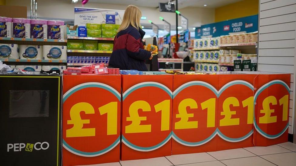 A woman in a Poundland store